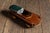 Figural tobacco box carved in the form of an early open-top automobile, closely resembling a 1920s touring car or roadster...