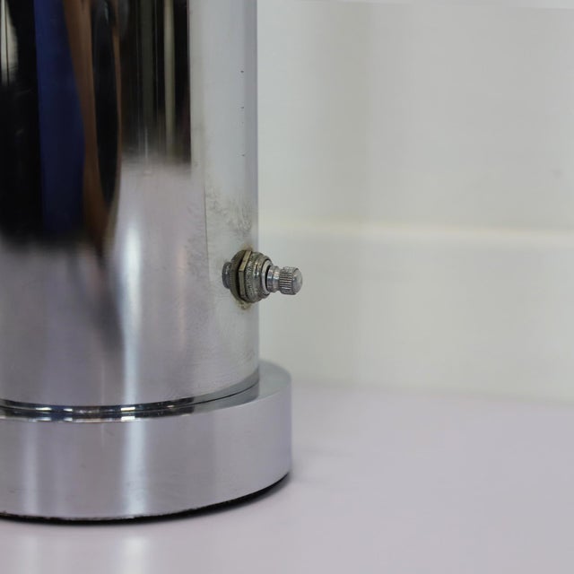 An interesting chrome-plated table lamp, designed by Angelo Lelli for Lightolier, circa 1960s. The cylindrical body of the...