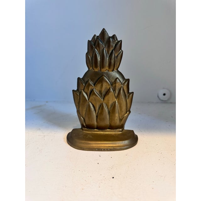 This is a vintage brass pineapple shaped door stopper, which can also be used as a book end. I’m also selling another one...