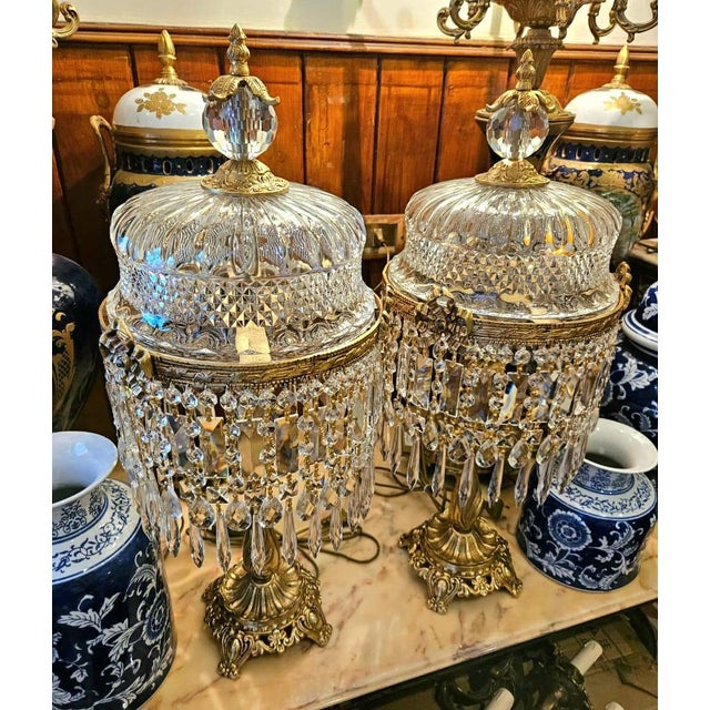 Elevate your space with this magnificent vintage crystal table lamp, featuring an ornate metal frame adorned with silver...