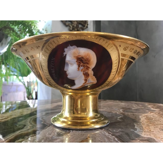 stunning porcelain fruit bowl fit for an Emperor. One side displays in the style of a cameo on a rich burgundy background...