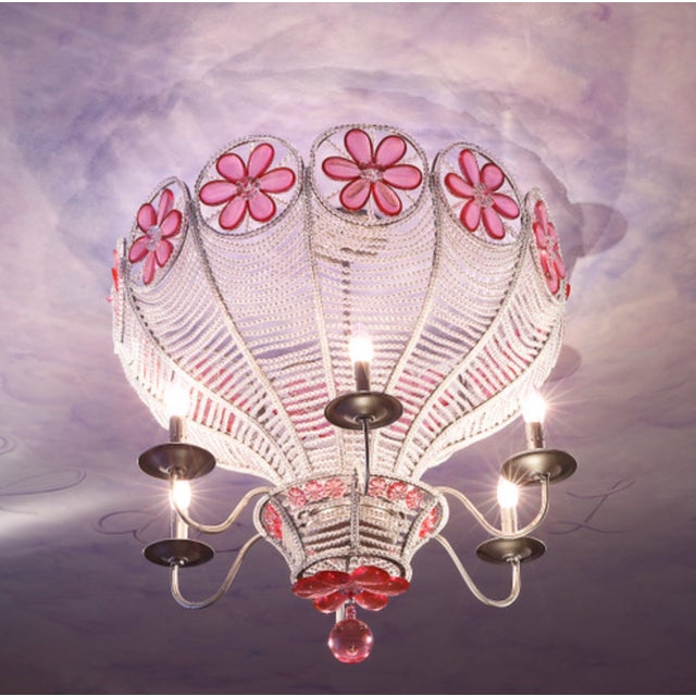 This is a hand strung, beaded chandelier featuring pink crystal flowers. Characteristics: Hand-strung crystal beading with...
