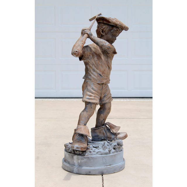 Celebrate the timeless charm of golf with this impressive vintage life-size boy golfer garden statue. Crafted from durable...