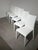Elegant set of six Italian-design dining chairs upholstered in white leather. Featuring tall, gently curved backrests and...