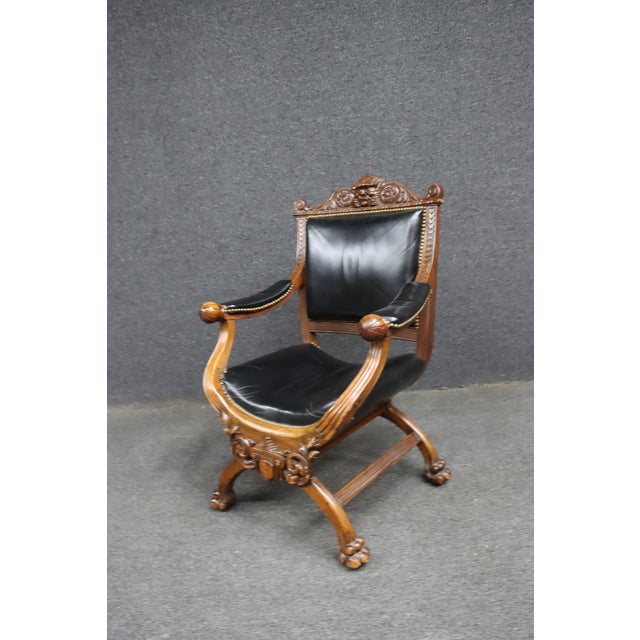 Late 19th century Renaissance Revival Savonarola armchair crafted in solid walnut with a folding X-frame base. The chair...