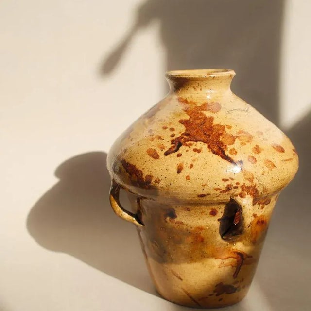 A richly glazed earthenware vase with four applied loop handles. Possibly from Soufflenheim, this piece reflects the...