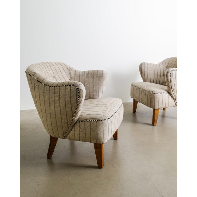 A rare and early scandinavian mid century modern sculptural armchairs model "ingeborg" in beech wood and the original wool...