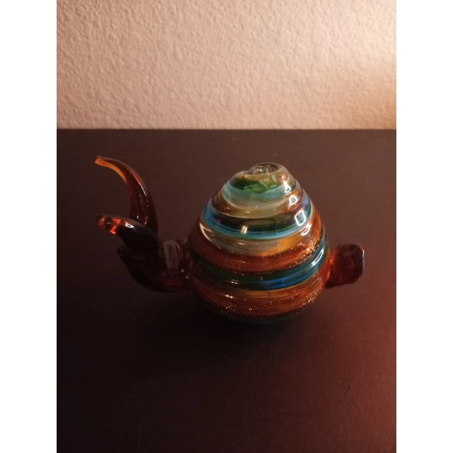 This is a Multicolor Art Glass 6" Snail Figurine Procured at an auction