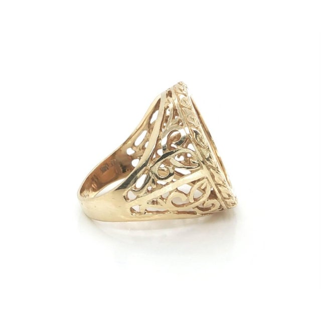 This authentic vintage coin ring is crafted in 14k yellow gold and features a beautifully framed $5 Liberty gold coin in...