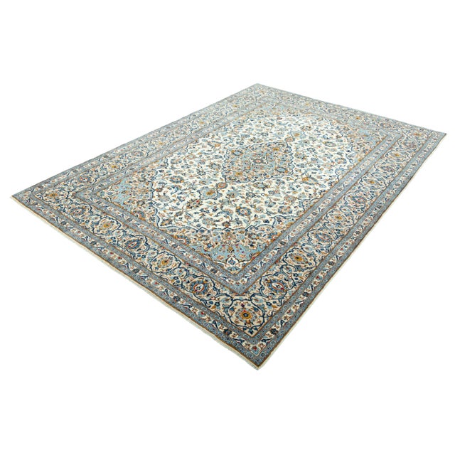 A classic Kashan in an extraordinary size and rare color composition: fine floral arabesques in sky blue, golden beige and...