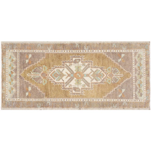 This Vintage Turkish Oushak Yastic rug measures 1'8" x 3'9" and is handcrafted in Turkey. Made from high-quality wool and...