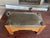 Here is an antique Arts and Crafts/Mission-style oak footstool with green leather secured by decorative metal tacks,...