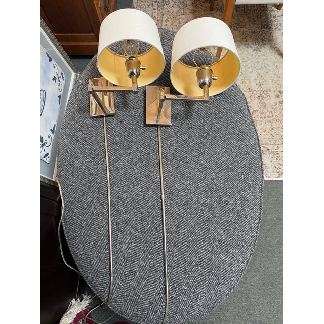 Design Plus Gallery presents a Pair of Corded Swing Arm Wall Sconces from Pottery Barn. These traditional sconces are...