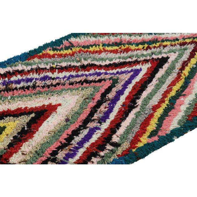 Hand-knotted in wool and originating from Morocco circa 1950-1960, this 3x6 vintage Moroccan rug is an extremely rare...