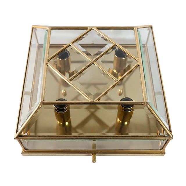 Italian flush mount chandelier is made of rectangular gold-plated metal base with faceted glass details in the frames....