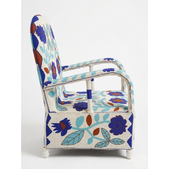 Elevate your space with this magnificent hand-beaded armchair, a vibrant testament to the artistry of the Yoruba people of...