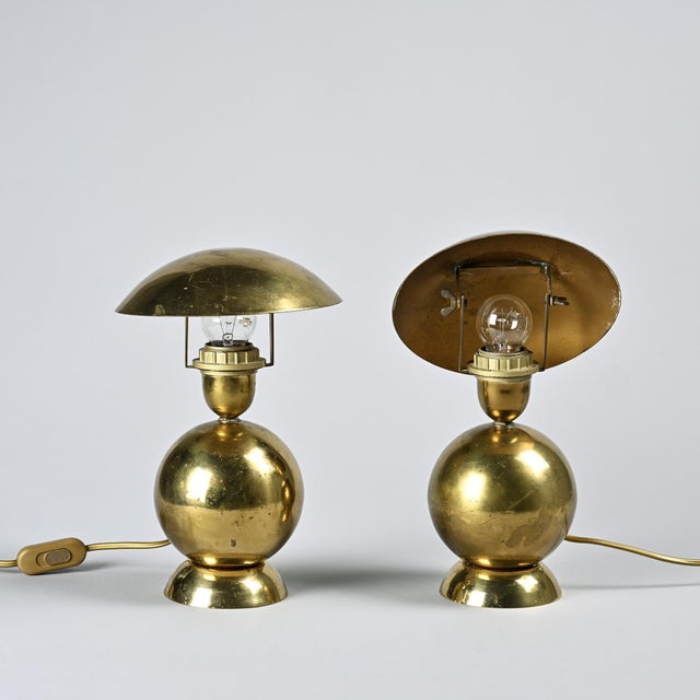 Pair of table lamps produced by Mathias in France around 1970. Each lamp rests on a circular base supporting a polished,...