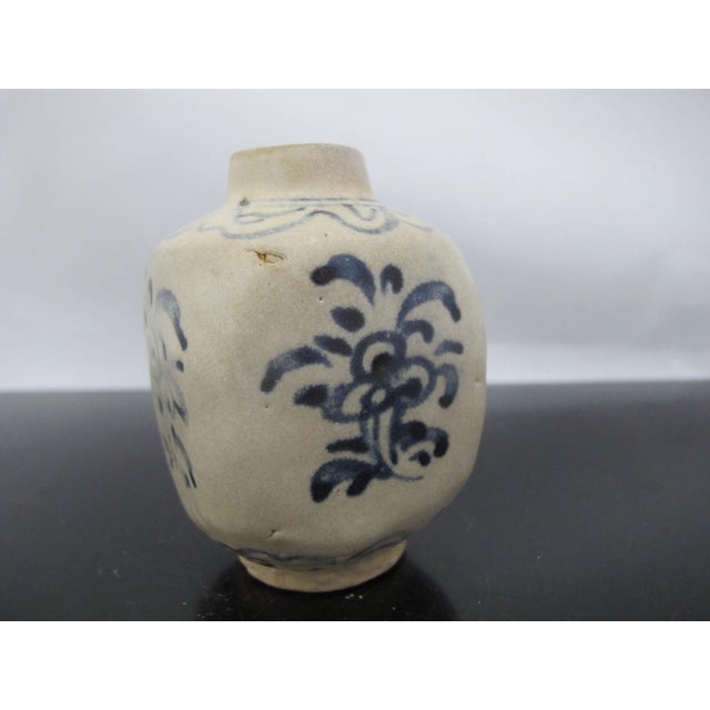 Antique Annamese (Vietnamese) blue and white ceramic jarlet or vase with a floral motif on all 4 sides. Measures 3 1/2"...