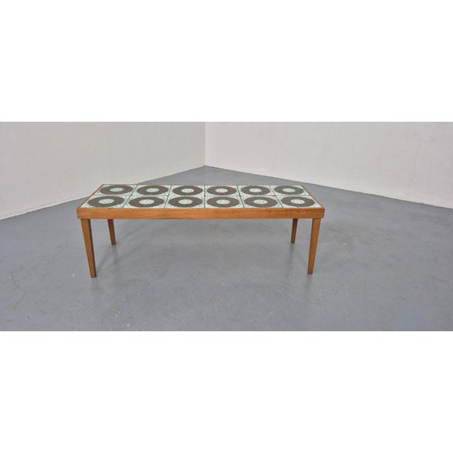 A flower stand or coffee table from the 1960s. The tabletop is covered with ceramic tiles.
