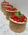 Fun set of four vintage 1970s era ceramic canisters with a basket weave pattern base and a lush deep red strawberry bushel...
