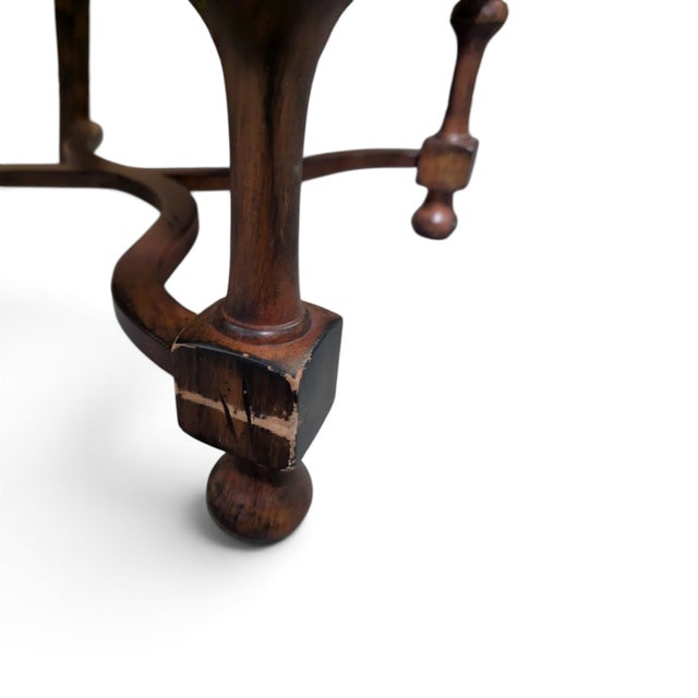 A tall, sculptural armchair in the Louis XIII tradition, pairing a high upholstered back and generous seat with gracefully...