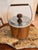 Vintage Kromex insulated ice bucket featuring a faux walnut woodgrain exterior, chrome-plated lid and trim, and original...