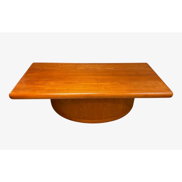 A striking Danish modern executive desk by Dyrlund, crafted in rich teak with the brand's signature soft, rounded edge...