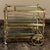 Mid-Century Modern Brass & Glass Bar Cart makes the perfect addition to your entertaining room! Set on spoked wheels on...