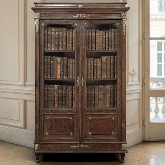 A refined 19th century French Louis XVI bookcase crafted in acajou moucheté mahogany, one of the most prized and rare...