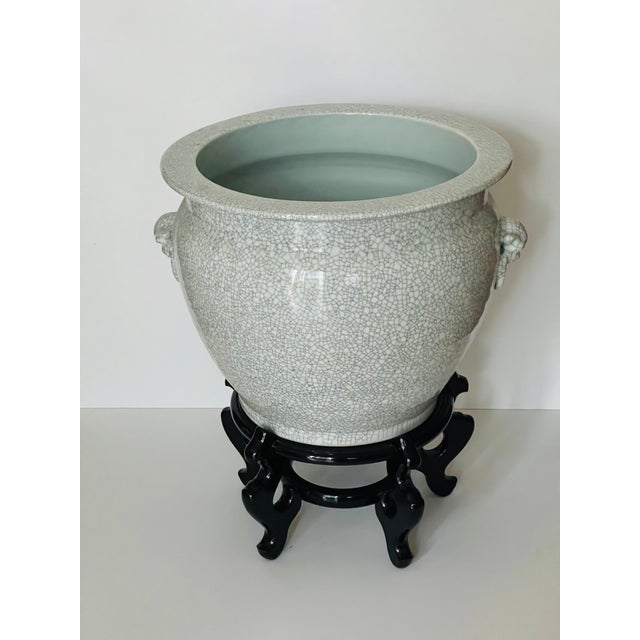 Antique Chinese craquellure porcelain large and heavy planter with lion handles and matching lacquer wood stand.