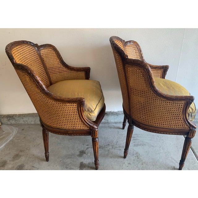 Lovely pair of Theodore Alexander Bergere accent chairs. Exquisite hand carving and made to endure the test of a lifetime!