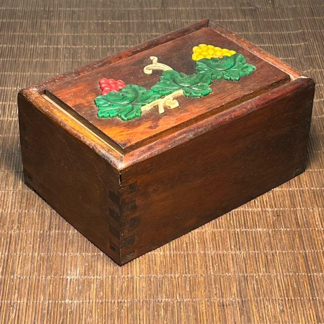 A handsome carved hardwood sliding drawer box, its surface inlaid with intricate bone work depicting green leaves,...