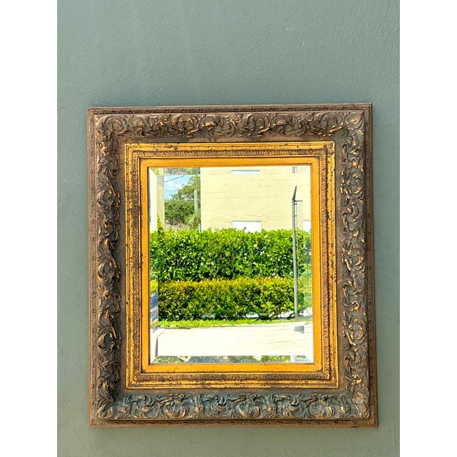This vintage gilt wood wall mirror embodies the elegance and decorative richness of Baroque Revival design. Expertly...