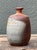 This exquisite vintage bud vase is a masterful example of Raku studio pottery, embodying the rustic elegance of the...