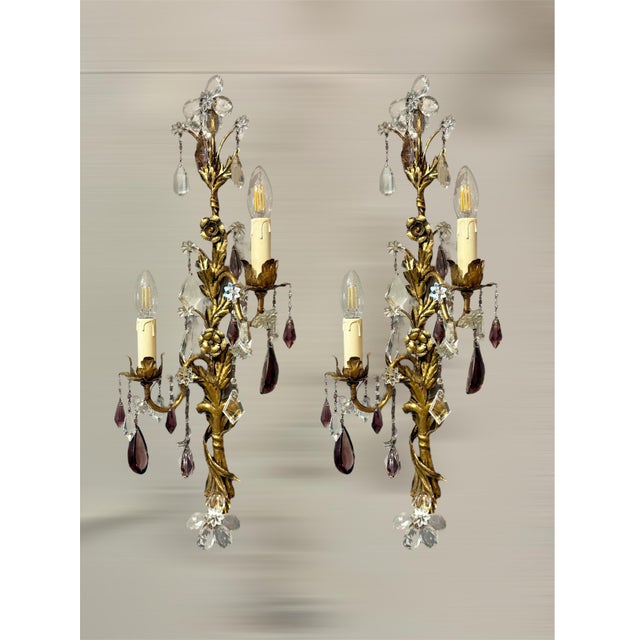 This elegant pair of Italian wall lights, dating from the 1950s, is crafted in gilt brass with refined Bohemian crystal...