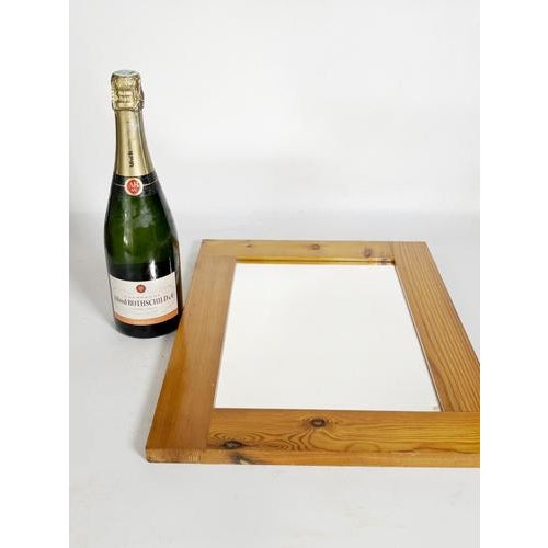 An elegant solid pine wall mirror dating from the 1970s, crafted in the spirit of Charlotte Perriand's design. Its simple...