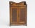A small antique smokers cabinet with amazing hand carved floral details in the front doors. Overall the wall cabinet has...