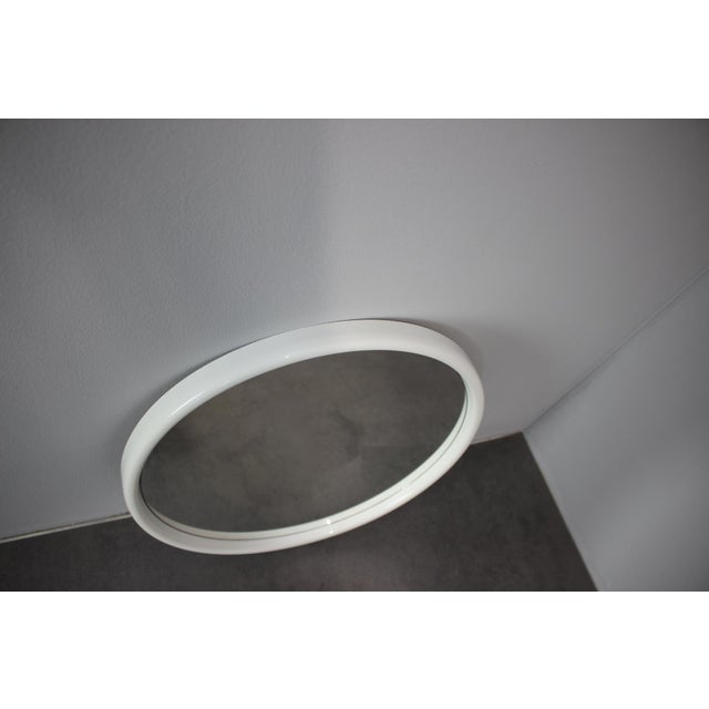 Minimalist Mid-Century round mirror manufactured by APPL Spiegel in Germany during the 1960s. The piece features a rounded...