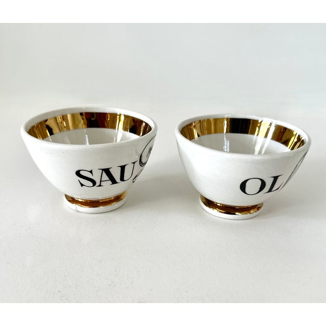 Two small appetizer bowls designed by Piero Fornasetti. Sausages and Olives from an original set of 6. 2" H X 3" diameter....