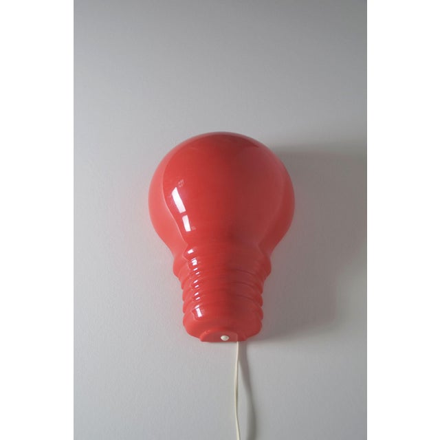 Pop Art wall lamp from the 1980s in the shape of a red light bulb. It was manufactured by the German company Zicoli...