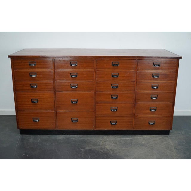 This apothecary cabinet was made circa 1950s in the Netherlands. The cabinet was used in a fabrics shop as a counter. It...