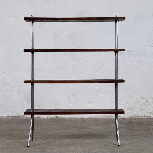This minimalist shelving unit embodies the functional elegance of the Bauhaus movement, featuring a clean combination of...