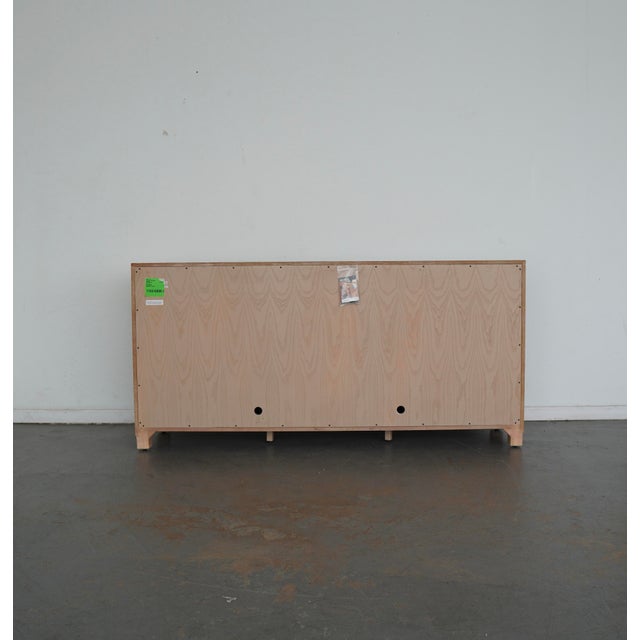 The buffet features a sunburst veneer pattern on the doors crafted from white ash, oak, pecan and walnut veneers. The...