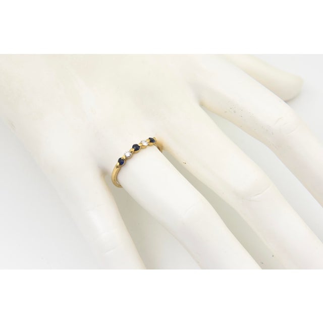 Vintage 14K Yellow Gold Sapphire and Diamond Five-Stone Ring An elegant five-stone ring crafted in 14K yellow gold,...