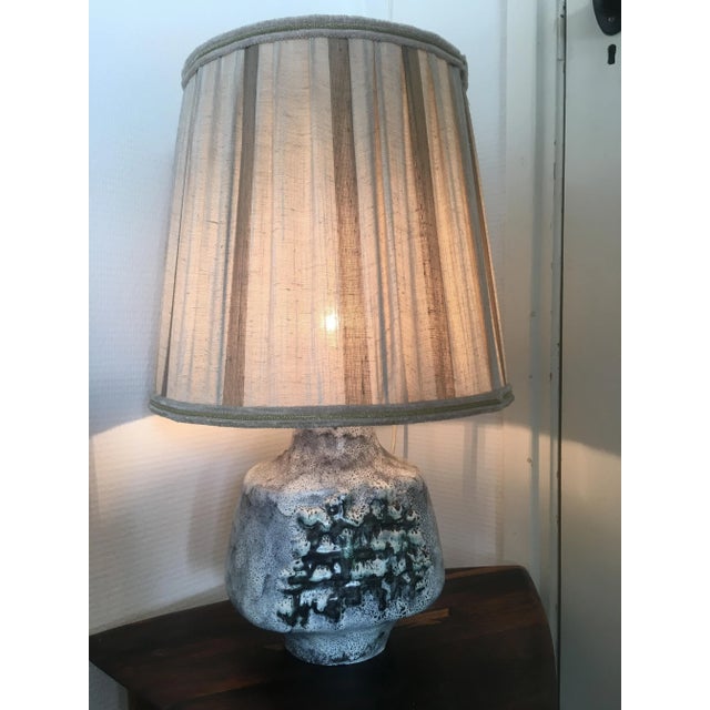 This Mid-Century ceramic table lamp still has its original fabric shade. European Plug (up to 250V).The wiring of this...