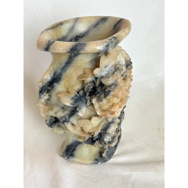 This gorgeous soapstone vase has beautifully carved flowers and leaves on the front side. As you might assume it is quite...