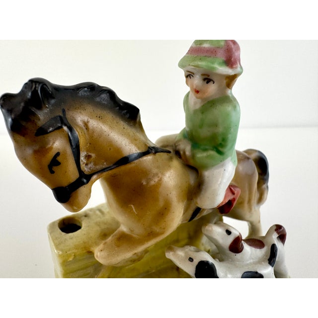 Charming vintage porcelain figural holder by Hiten Japan featuring a young rider atop a horse accompanied by two playful...