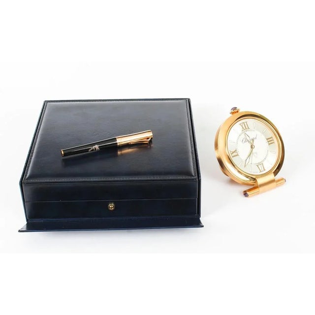 A majestic presentation compendium comprising a Chopard Imperiale travelling alarm clock and a Chopard pen, late 20th...