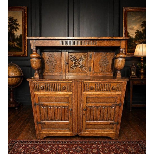 An impressive large solid oak sideboard dresser combining substantial craftsmanship with richly decorative carved...
