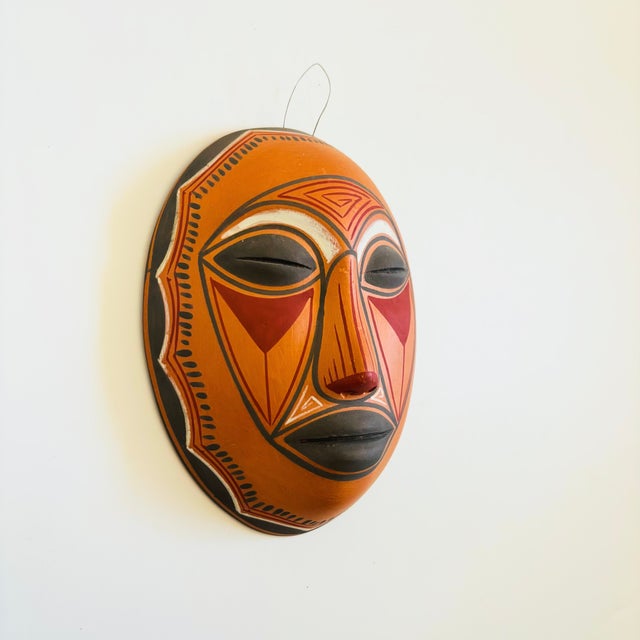 A wonderful vintage terra cotta pottery mask wall hanging. Natural unglazed finish with beautiful hand painted designs...